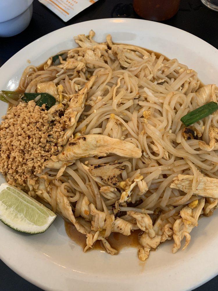 Pad Thai · Thai famous stir-fried thin rice noodles with special pad thai sauce, eggs, green onions, and bean sprouts. Garnished with a side of fresh lime and ground peanuts.
