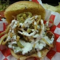 Sizzler Burger · Pepperjack cheese, fried jalapenos, crispy haystack onion rings, on top of a fresh 5 oz. pat...