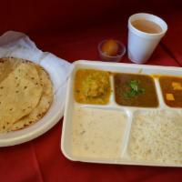 Vegetarian Thali Platter · A combination of 2 vegetable curries, daal makhni, basmati rice, 1 roti, raita, papadam, des...