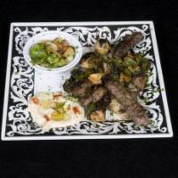 Mixed Grill · Combination of lamb, chicken and kufta kabab. Served with sauteed vegetables, basmati rice a...