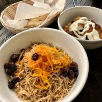 Kabuli Pallow Bowl · Afghan style rice. Baked with chunks of lamb tenderloin, raisins and glazed julienne of carr...