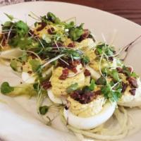 Deviled Eggs · Jumbo stuffed eggs with bourbon candied bacon and herb oil