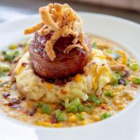 Bacon Wrapped Meatloaf · Smoked and bacon-wrapped meatloaf atop loaded mashed potatoes, with creamed corn.