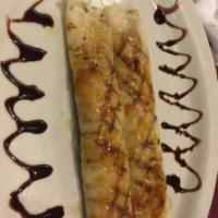 Panqueques · 2 crepes filled with dulce de leche, topped with melted sugar with whipped cream and chocola...