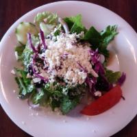 Greek Salad · Fresh romaine lettuce sprinkled with feta cheese, Kalamata olives, garden vegetables and Rus...