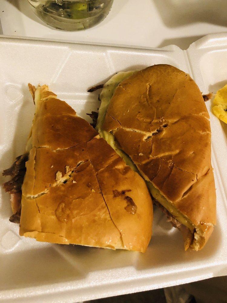 Cuban Sandwich · Big sandwich. Butter, ham, roasted pork, swish cheese, mustard, pickles in a Cuban bread. Done in a hot press machine.