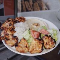Chicken Kabob Plate · Marinated chicken breast pieces grilled on skewers with garlic sauce. Served with hummus, ri...