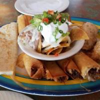 Empanadas · 2 ground beef turnovers served with black beans and guacamole.