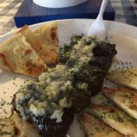 Dolma · The famous Greek appetizer is 6 stuffed grape leaves with rice and served in our own lemon j...