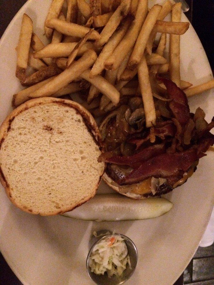 Lodge Burger · Topped with sautéed mushrooms, onions, crisp bacon, and cheddar cheese on a pretzel bun