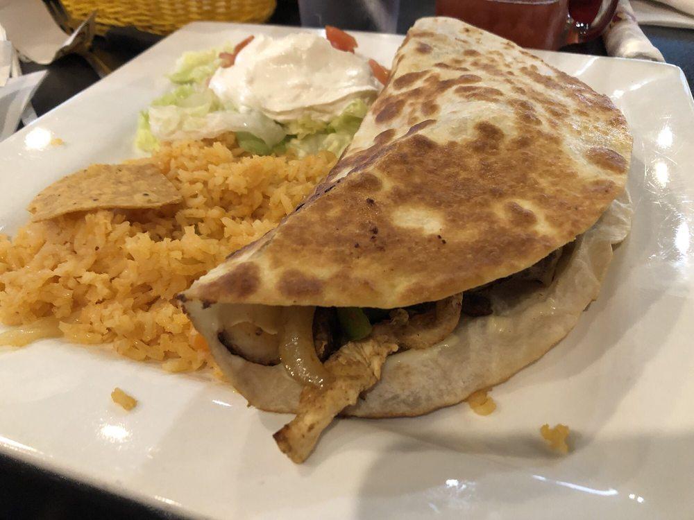Fajita Quesadilla · The most popular quesadilla, filled with quality melted cheese, choice of steak, grilled chicken, or both mixed, with grilled onions, tomatoes and bell peppers, served with rice and coleslaw.