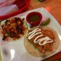Chicken Tinga Taco · Pulled chicken marinated in authentic Mexican spices, cooked in onions, tomato and spicy chi...