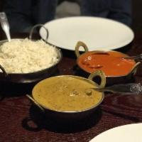 Butter Chicken · Traditional chicken entree prepared in butter tomato sauce. Dark meat. Served with basmati r...