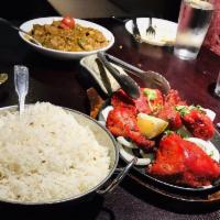 Chicken Tandoori · Savory yogurt-marinated chicken roasted to perfection on clay oven and served in sizzling pl...