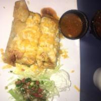 Chimichanga · Two of our famous hand rolled and fried to golden brown chimichangas, with rice and refried ...