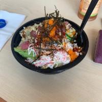 Poke Bowl · Served with lettuce, seaweed salad, masago, crab meat, avocado, cucumber, pineapple, ginger,...