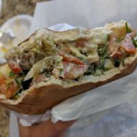 Falafel Pita · Chickpeas and broad beans, mixed with spices, fried, and stuffed in a pita with hummus, sala...