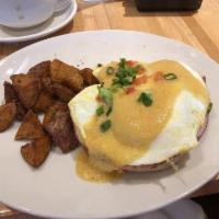Eggs Benedict · 2 halves of a honey-wheat English muffin topped with over easy eggs, sliced ham, diced tomat...