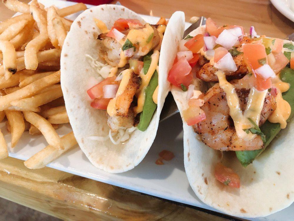 Grilled Shrimp Tacos · Grilled chili marinated shrimp in warm flour tortillas served with pico de gallo, avocado slices, cilantro slaw, and topped with sriracha aioli. 3 pieces