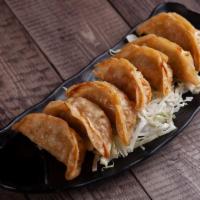 Gyoza · 7 pieces. Deep-fried pork potstickers with a side of soy vinegar and chili oil sauce.