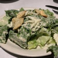 Caesar Salad · Crisp romaine lettuce with Parmigiana cheese, homemade creamy Caesar dressing and croutons.