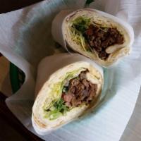 Lamb Shawarma Sandwich · Original hummus and grilled, marinated lamb pieces served on our house pita bread with lettu...