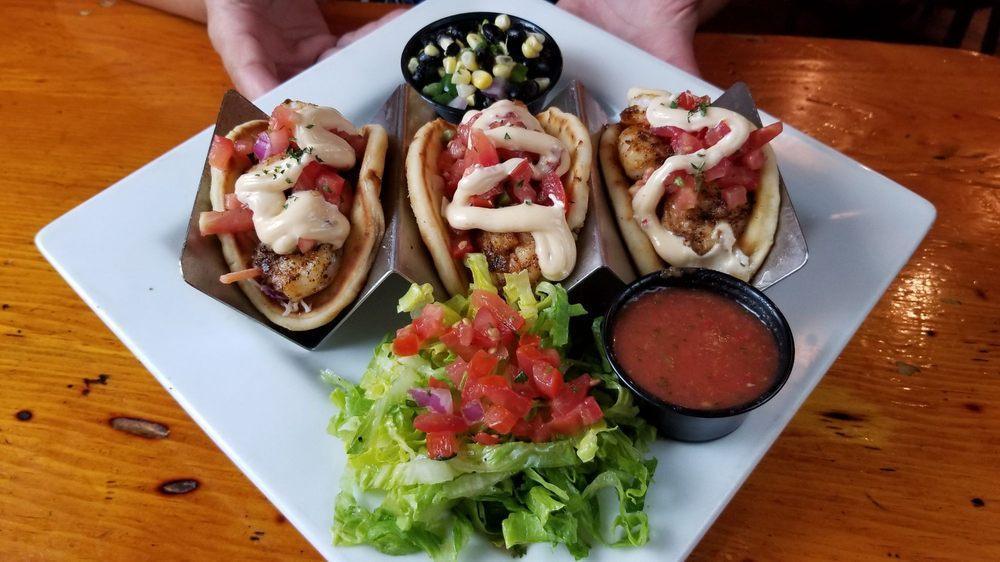 Blackened Shrimp Tacos · House-made Masa taco shells, served with coleslaw, pico, chipotle mayonnaise, and side of guacamole and salsa.