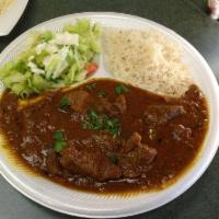 Lamb Curry Combo · Slow cooked chunks of lamb prepared in a special gravy & spices. Served with naan, rice & sa...