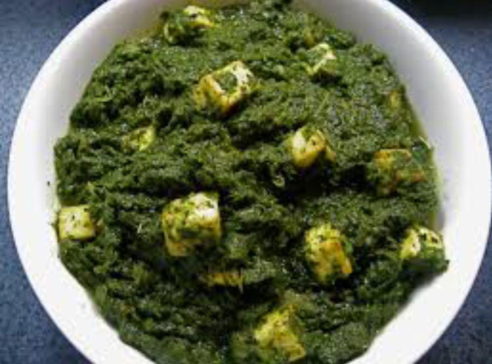 Palak Paneer · Spinach cooked with chunks of cheese. Served with naan, rice & salad.