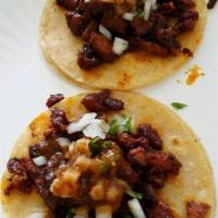 Tacos · Meat, onions, cilantro and hot sauce.