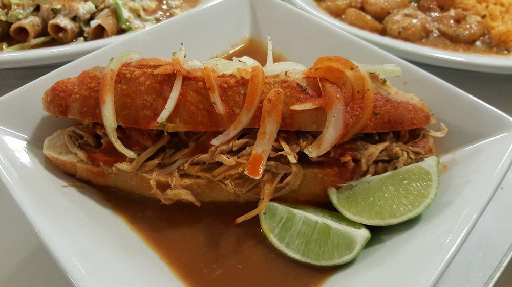 Torta Ahogada · Beans, pork carnitas, tomatoes salsa, and marinated onions drowned into our special hot sauce.
