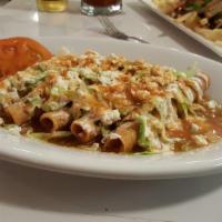Flautas · Deep fried rolled corn tortilla filled with shredded chicken and topped with lettuce, sour c...