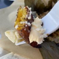 Maduros · Deep fried sweet plantains served with a side of crema and queso fresco.