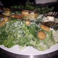 Caesar Salad · Romaine lettuce tossed in our creamy house caesar dressing with croutons and parmesan cheese.