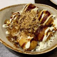 Takoyaki · Fried octopus dumplings drizzled with Japanese mayonnaise, katsu sauce and sprinkled with bo...