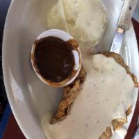 Country Fried Steak · Country fried steak smothered in cream gravy and served with choice of two sides