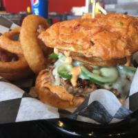 Ring of Fire Burger · 7 oz. Jalapeno, onion rings, pepper jack, Sriracha mayo, served on cheddar and jalapeno bun....