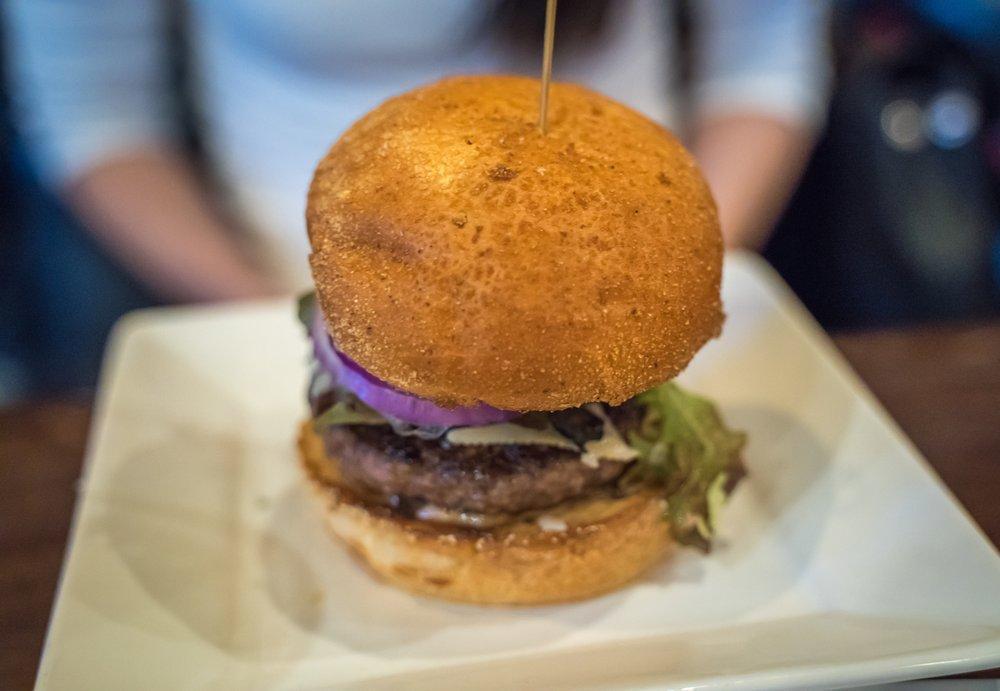 Bosscat Burger · In-house ground beef, bacon, cheese, lettuce, tomato, onion, housemade pickles and comeback.