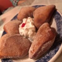 Sopapillas · Lightly fried pastries sweetened with sugar and cinnamon. Served with whipped cream, honey a...
