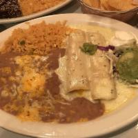Kid Cheese Enchilada · Topped with enchilada sauce and accompanied with Mexican rice and refried beans.