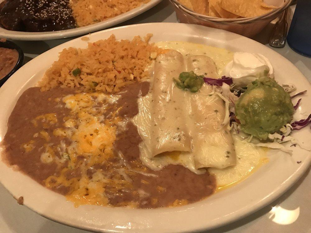 Kid Cheese Enchilada · Topped with enchilada sauce and accompanied with Mexican rice and refried beans.