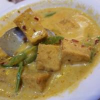 Panang Curry · Thai panang curry with coconut milk, peanut sauce, bell pepper, and basil served with steame...