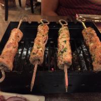 Chicken Reshmi Seekh Kabab · Minced chicken kababs grilled on skewers. Served with a side of chopped salad, sliced onions...