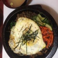 Bibimbap in a Hot Stone Pot · Served with steamed rice, miso soup, and sides (banchan).