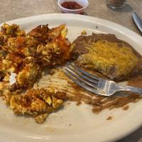 Migas · 3 scrambled farm fresh eggs cooked with chorizo, cheddar cheese, sauteed onions, tomatoes, b...
