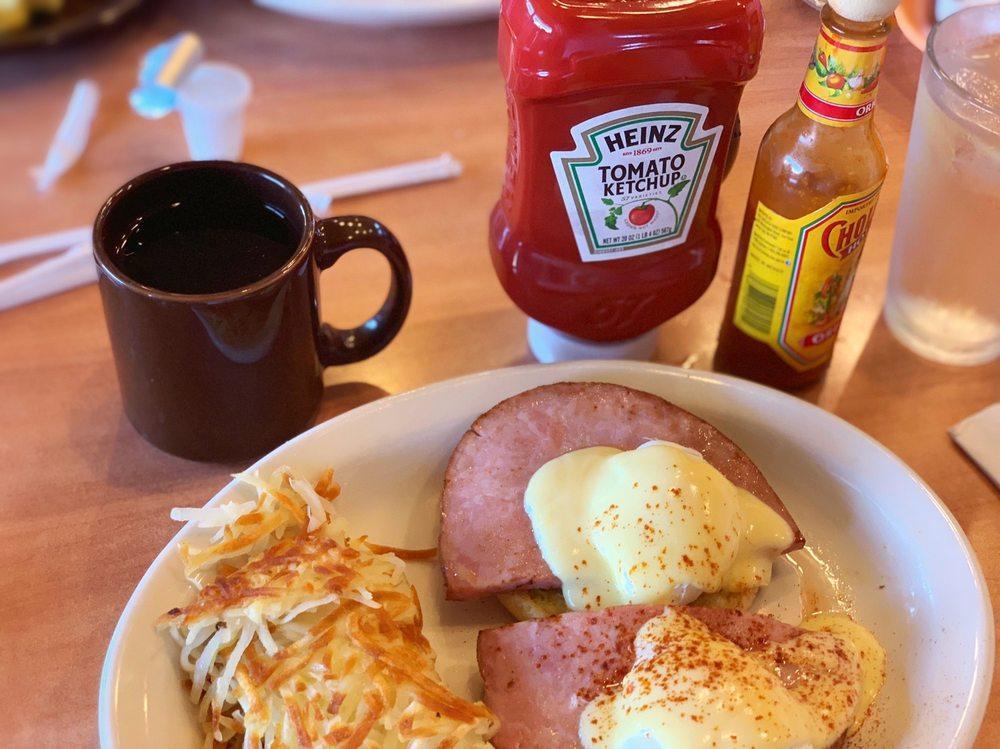 Eggs Benedict · 2 poached eggs and smoked ham over a toasted English muffin, topped with hollandaise sauce. Pancakes not included. Served with hash browns. Egg whites or low-cholesterol egg substitute available.