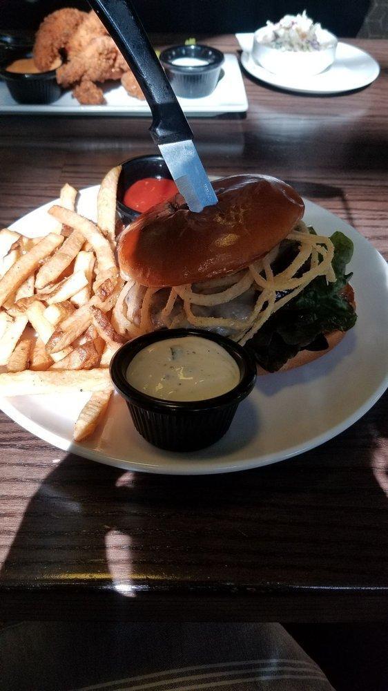 BBQ White Cheddar Burger · 1/2 lb. USDA choice lean ground beef patty prepared on a grilled pub bun spread with garlic aioli. Served with melted white cheddar cheese,
Black Butte BBQ sauce, crispy fried onion strings on red leaf lettuce and sliced tomatoes.