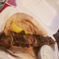 Lamb Skewer · Charbroiled lamb on a stick served with pita bread and tzatziki.