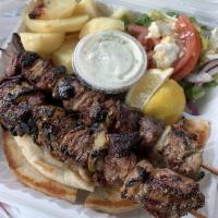 Lamb Skewer Platter · Served with a Mediterranean salad and a side.