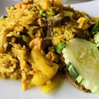 Pineapple Fried Rice · With egg, cashew nut, raisin, pea, carrot, onion, pineapple and curry powder.